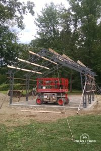 Edge mounted secondary wall members on each Clear Span Truss speed up DIY construction.